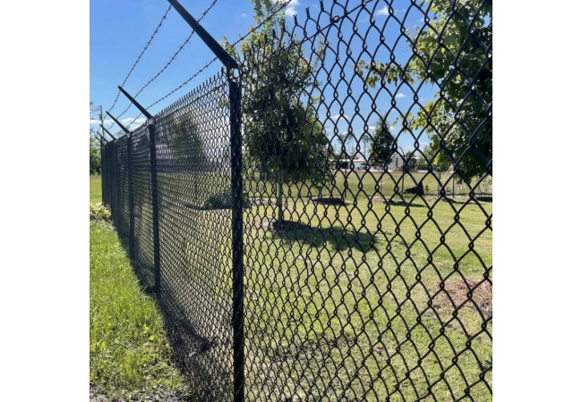 Commercial black PVC coated chain link fence installation with steel posts and gate system